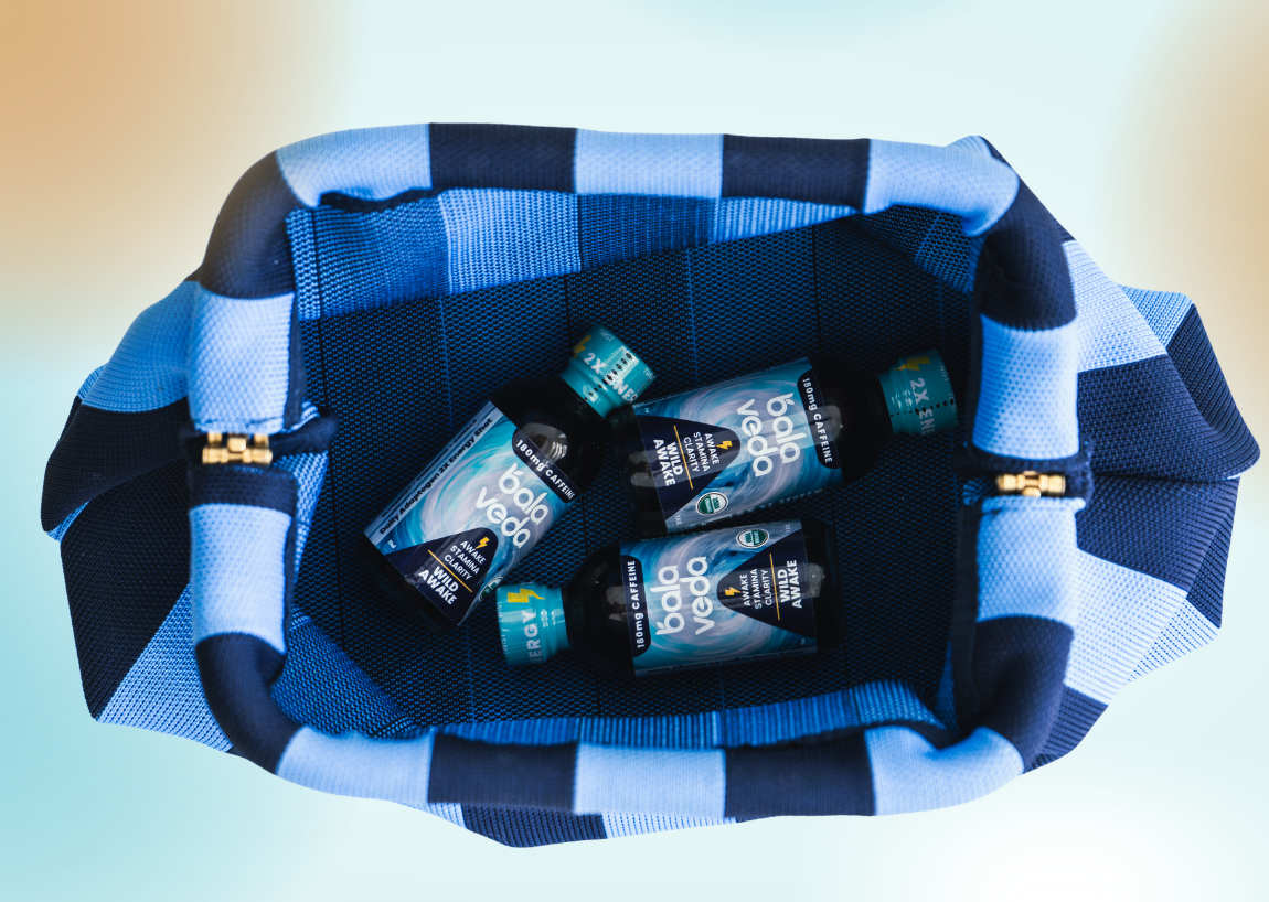 Blue and white striped bag with Wild Awake energy shots inside on a light blue background