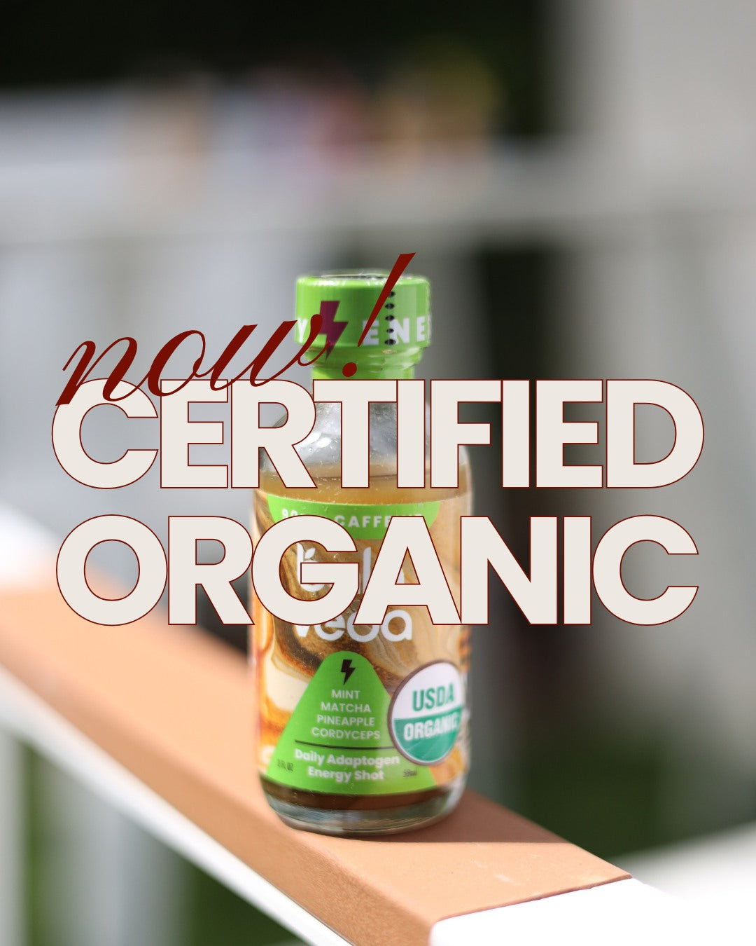 Bottle of certified organic product on a surface with text overlay stating "now! Certified Organic".