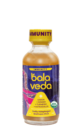 Balaveda totally turmeric immunity shot bottle with yellow cap on a transparent background