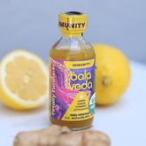 Bala Veda totally turmeric immunity bottle with lemons and ginger on a light background